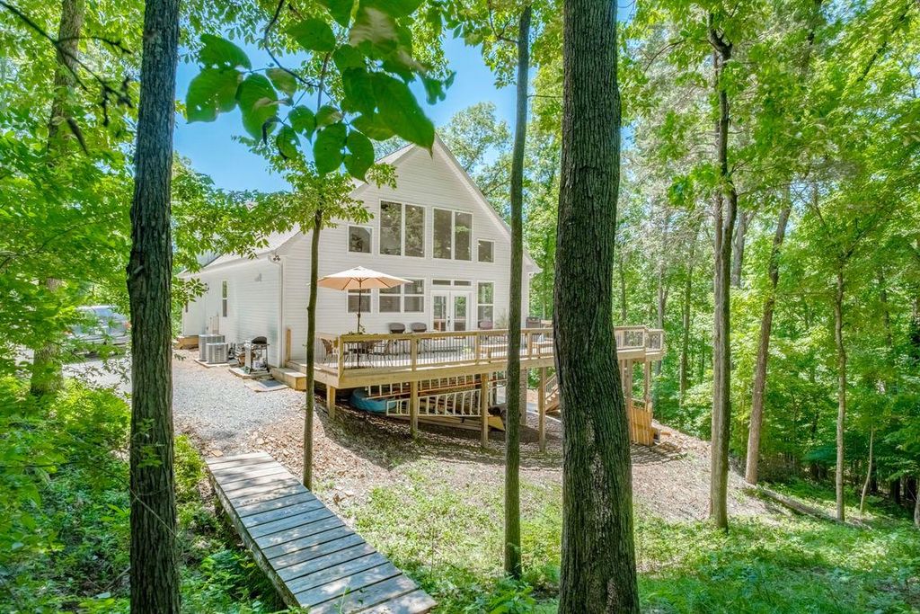 White House with large windows surrounded by trees